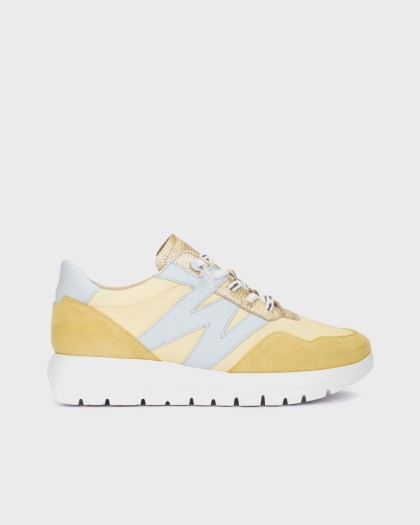 ODISEI 00 sneakers made from a combination of leather and textile in yellow and blue tones.