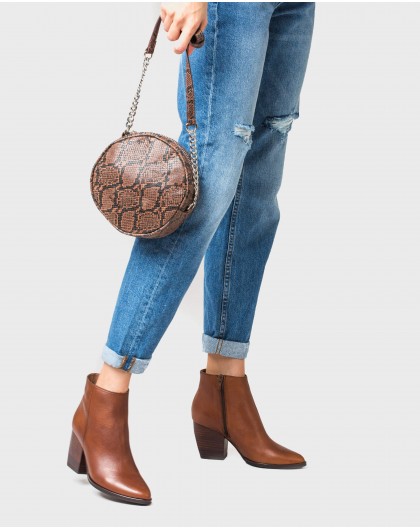 Circular handbag with crossbody strap